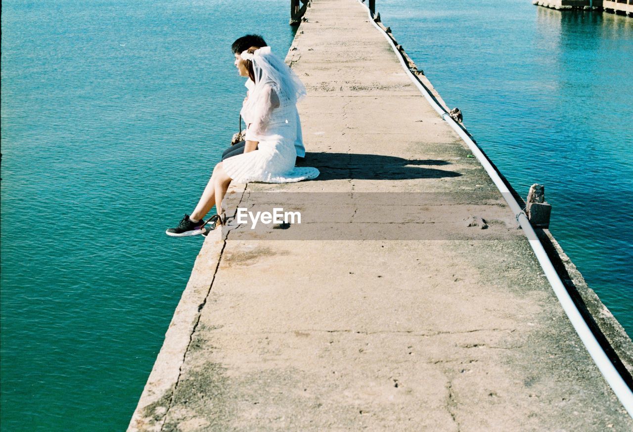 FULL LENGTH OF MAN SITTING ON BOAT