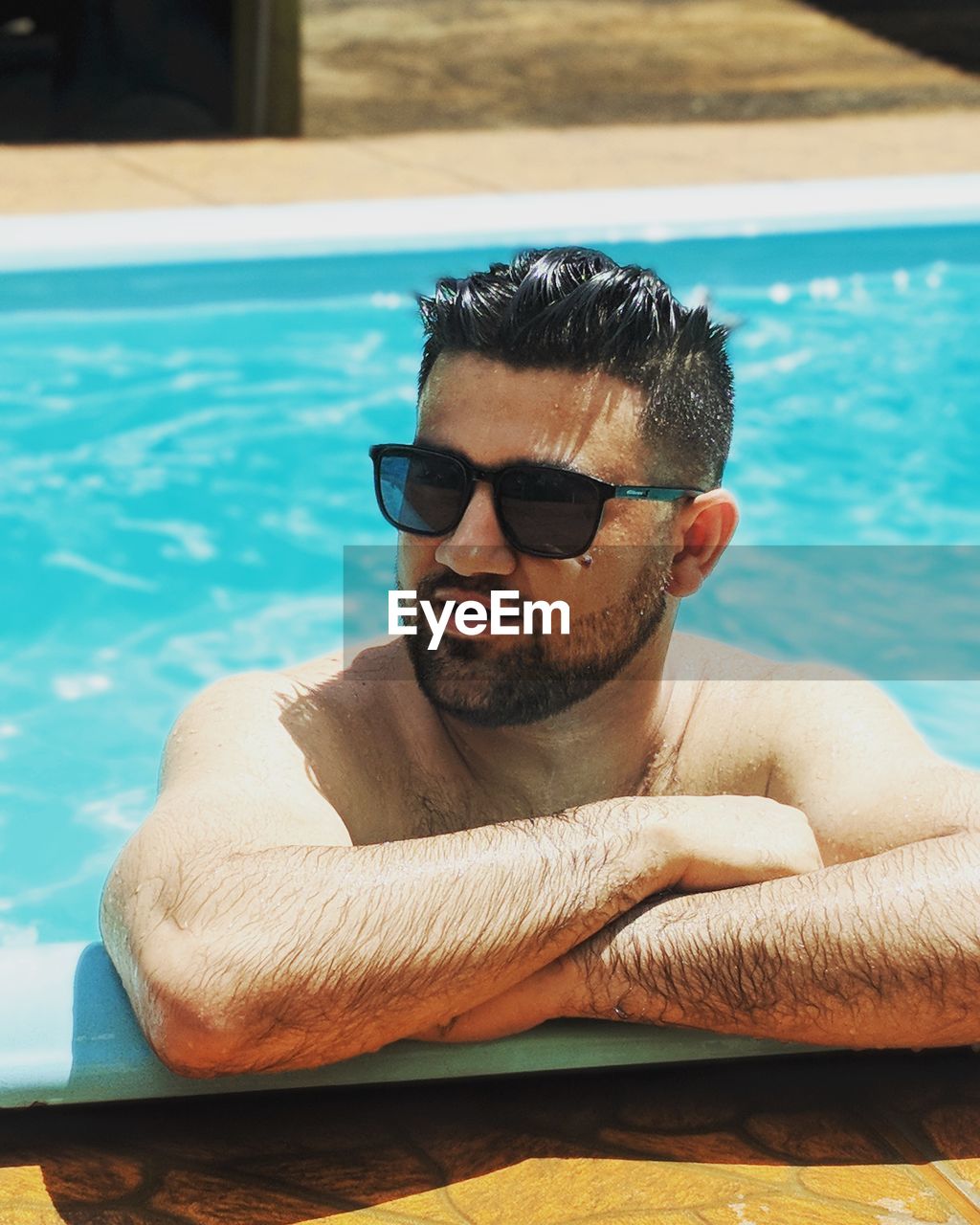 Man wearing sunglasses in swimming pool