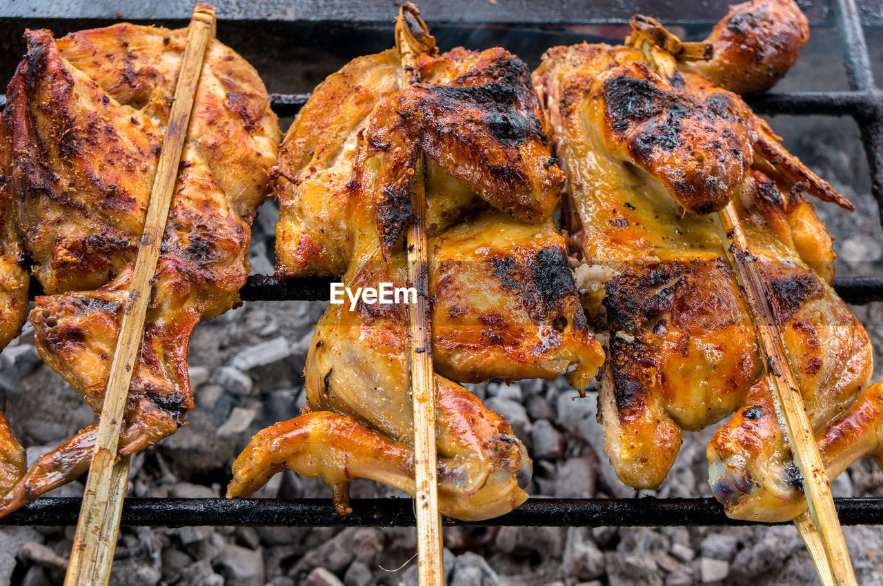 Hot skewer roasting chicken on grilled rack, thai local food