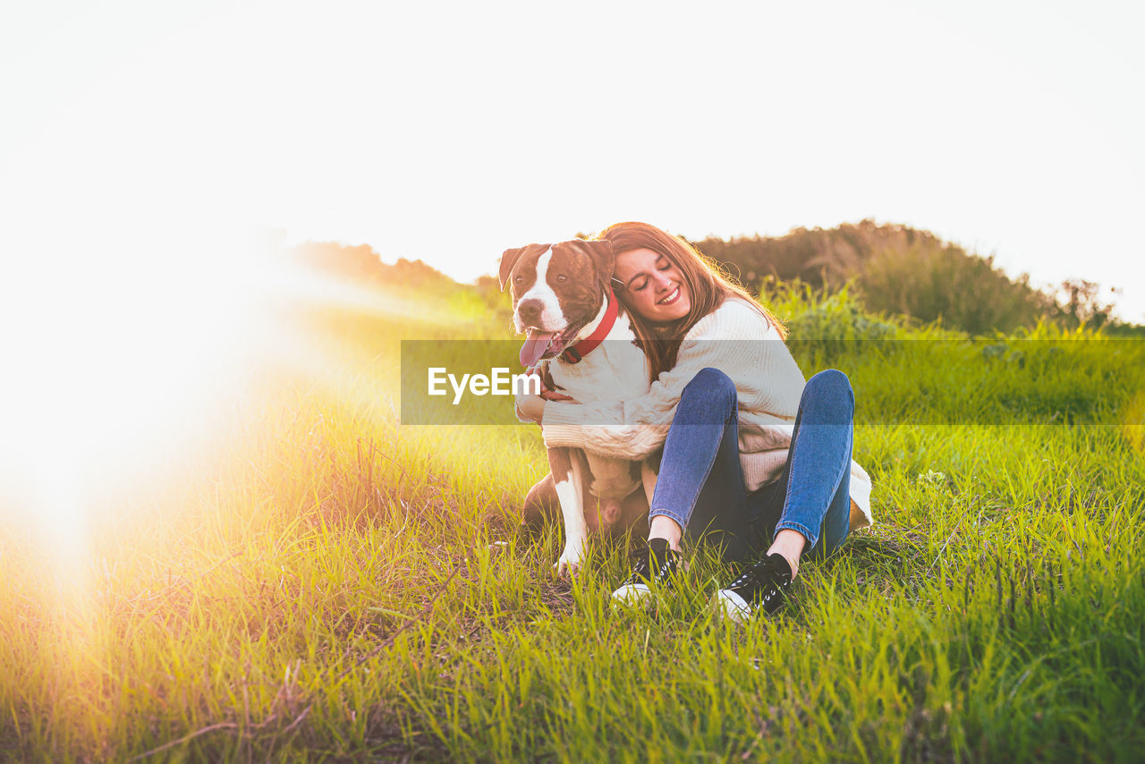 Woman with dog on field