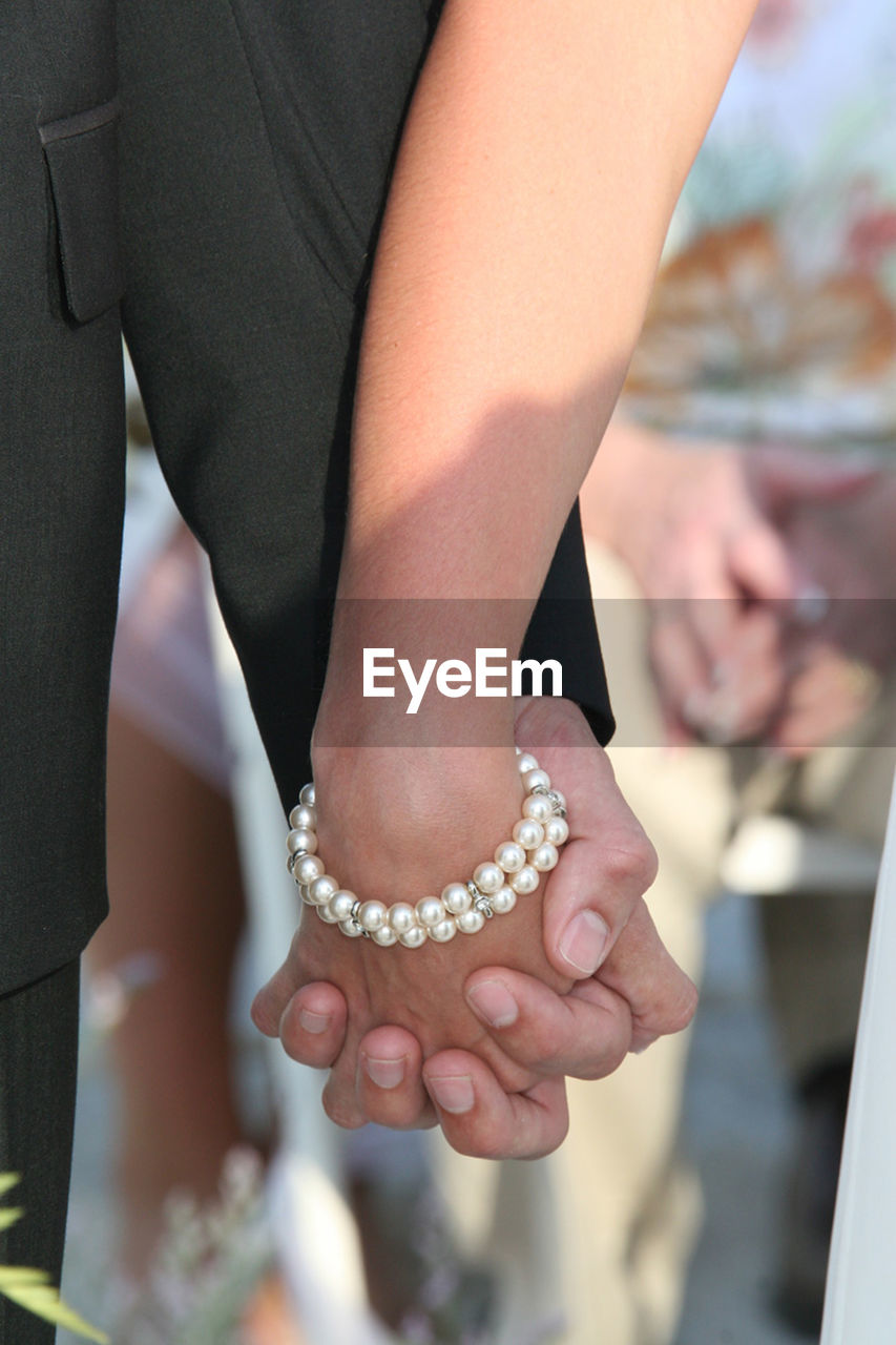 Couple holding hands at wedding