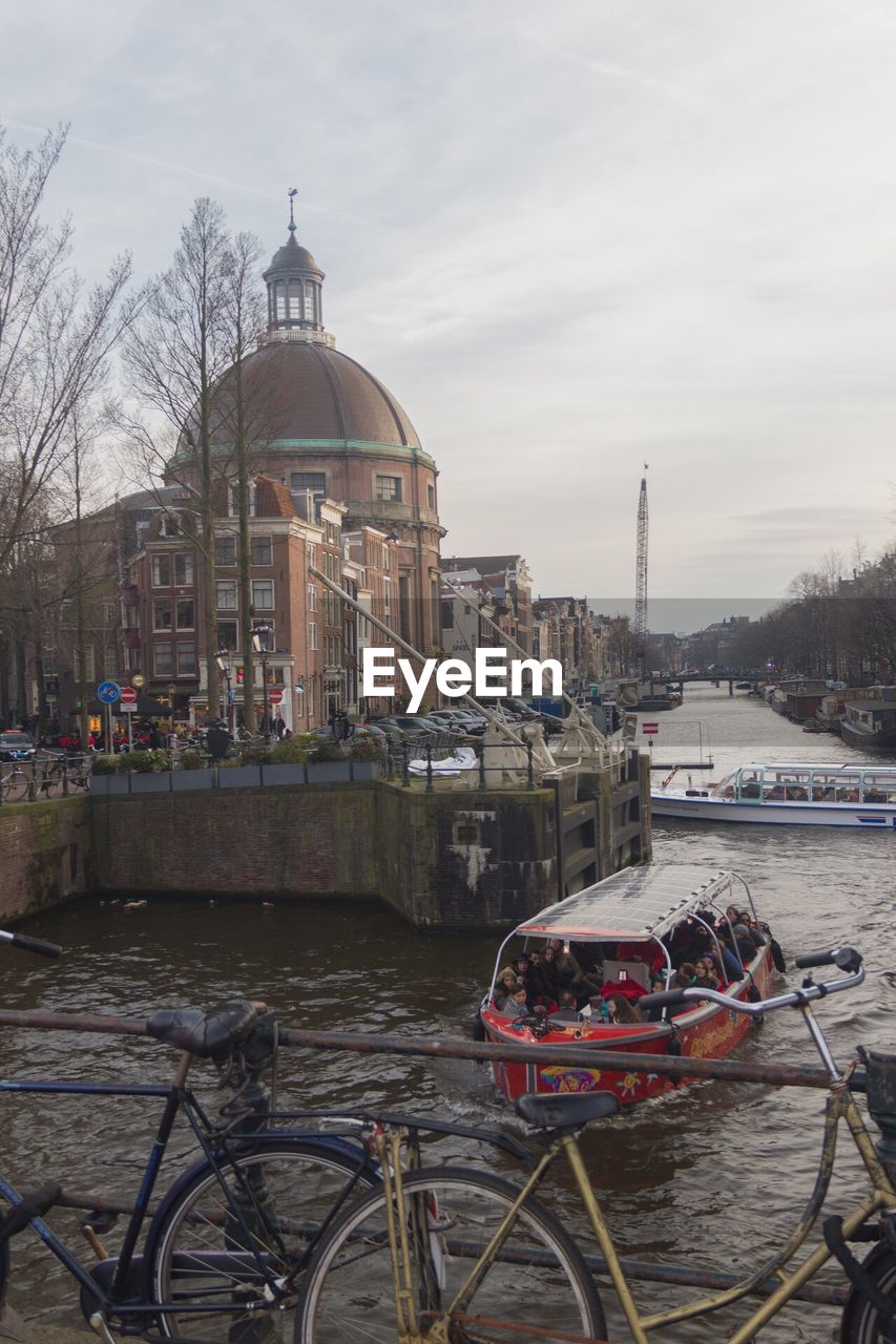 VIEW OF RIVER WITH BUILDINGS IN BACKGROUND