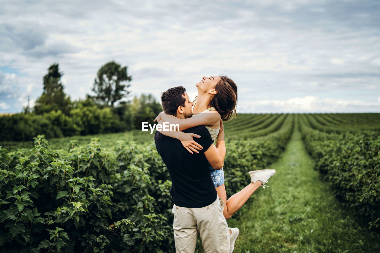 Full length of couple standing on field