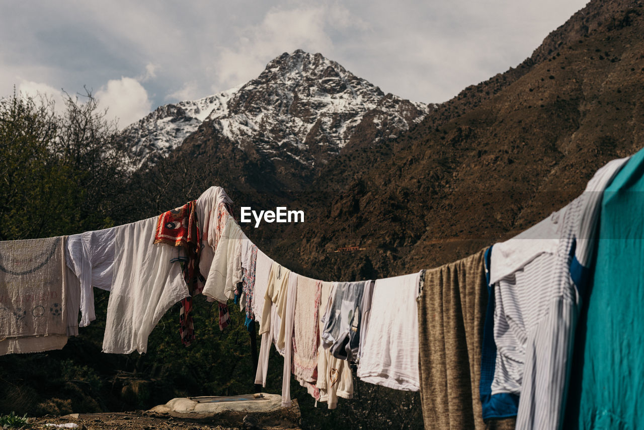 Clothes drying on clothesline against mountains