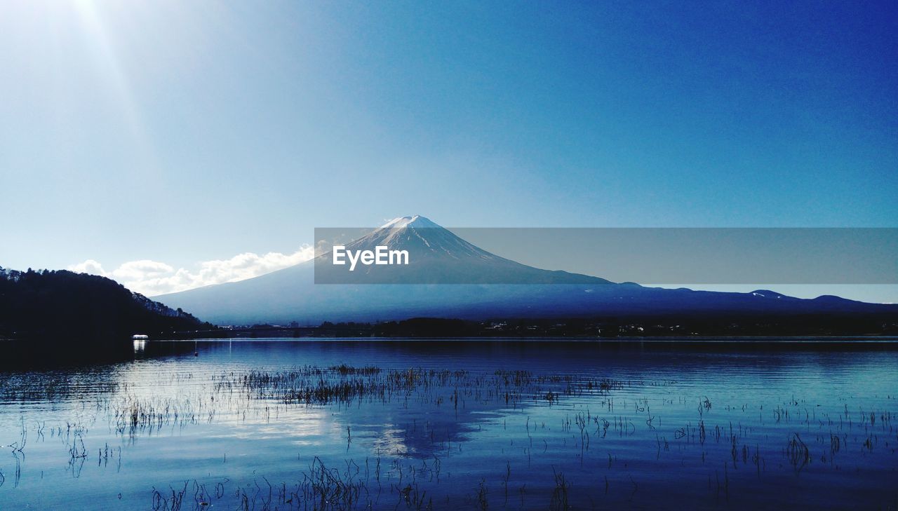 Scenic view of mt fuji reflection in lake kawaguchi against sky