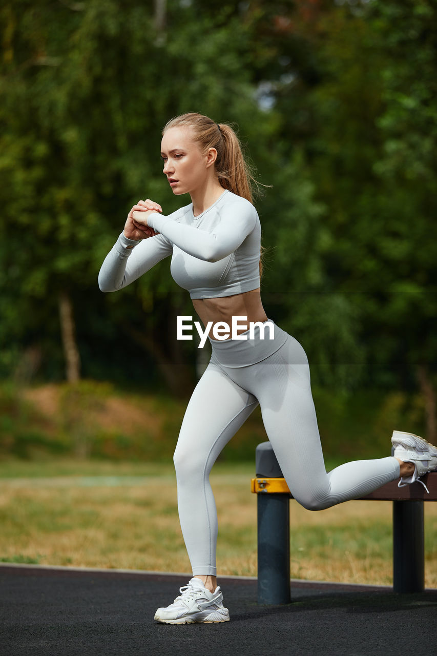 portrait of young woman exercising in park