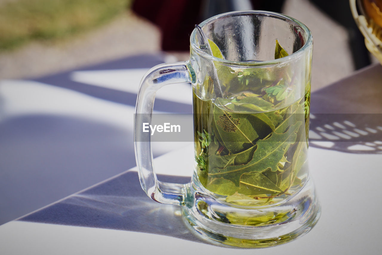 Traditional peruvian tea infusion from coca leaves in a mug, peru