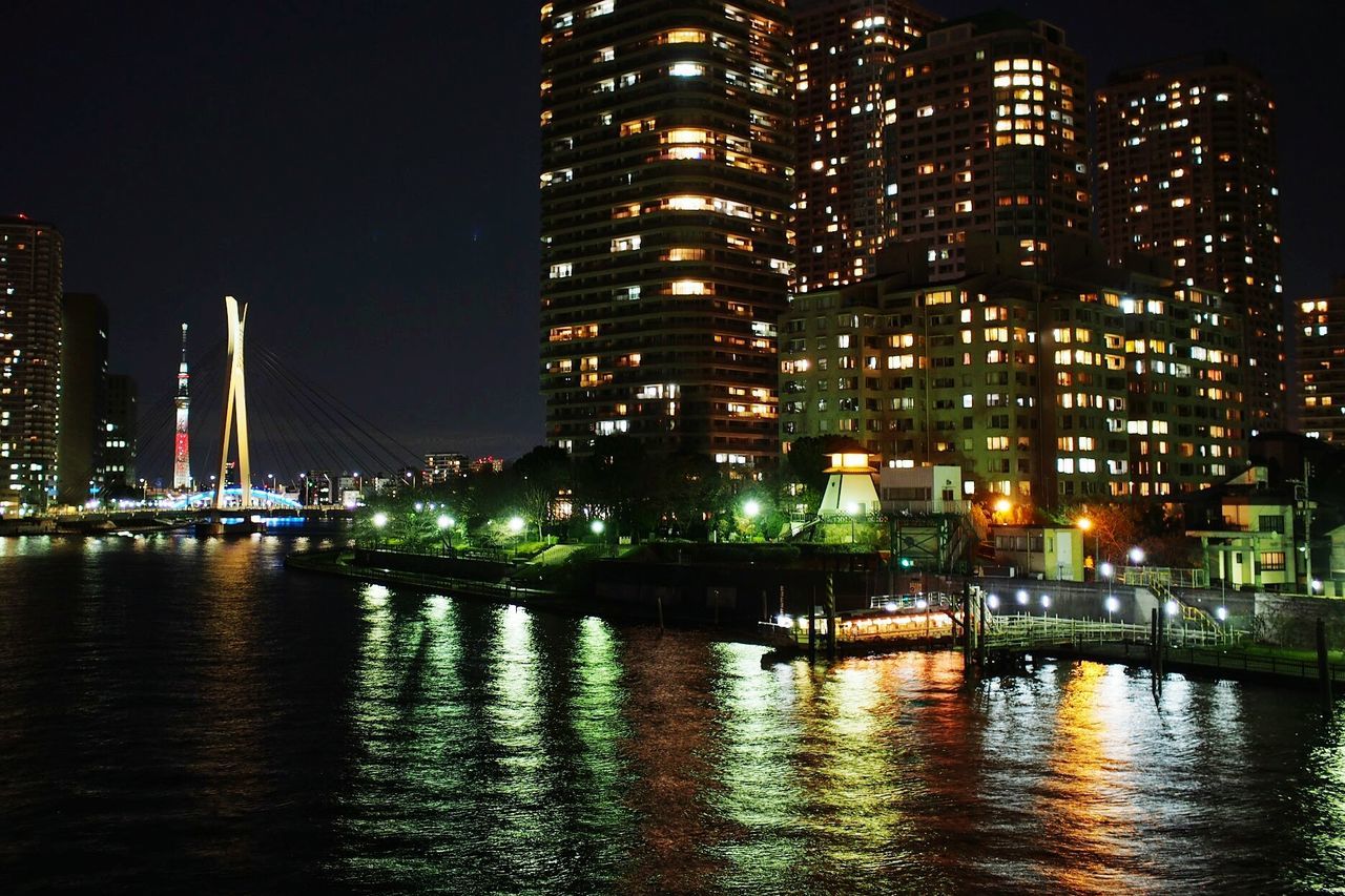 River and illuminated buildings in city