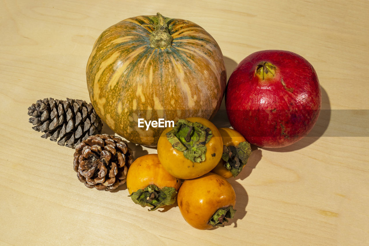 HIGH ANGLE VIEW OF FRESH FRUITS ON TABLE AGAINST WALL