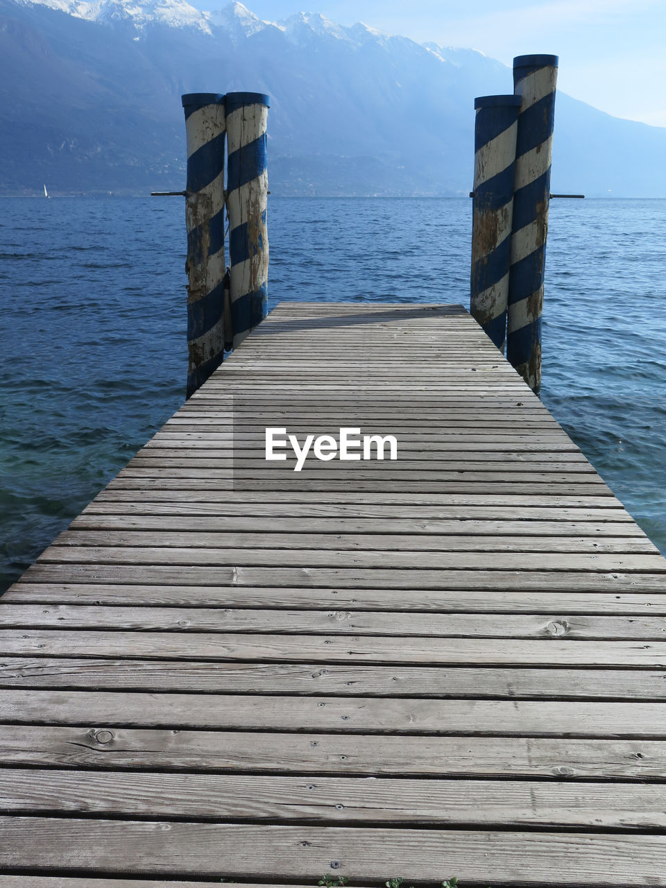 Wooden pier over sea against sky