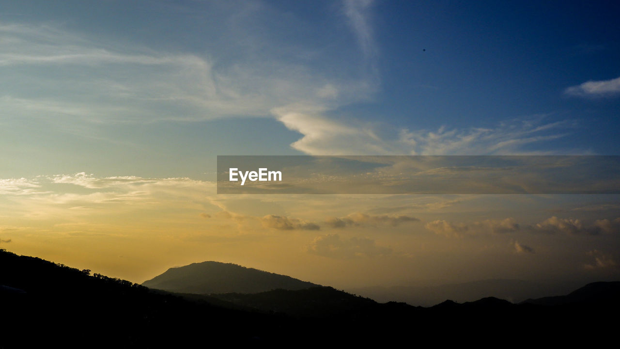 Scenic view of silhouette mountains against sky during sunset