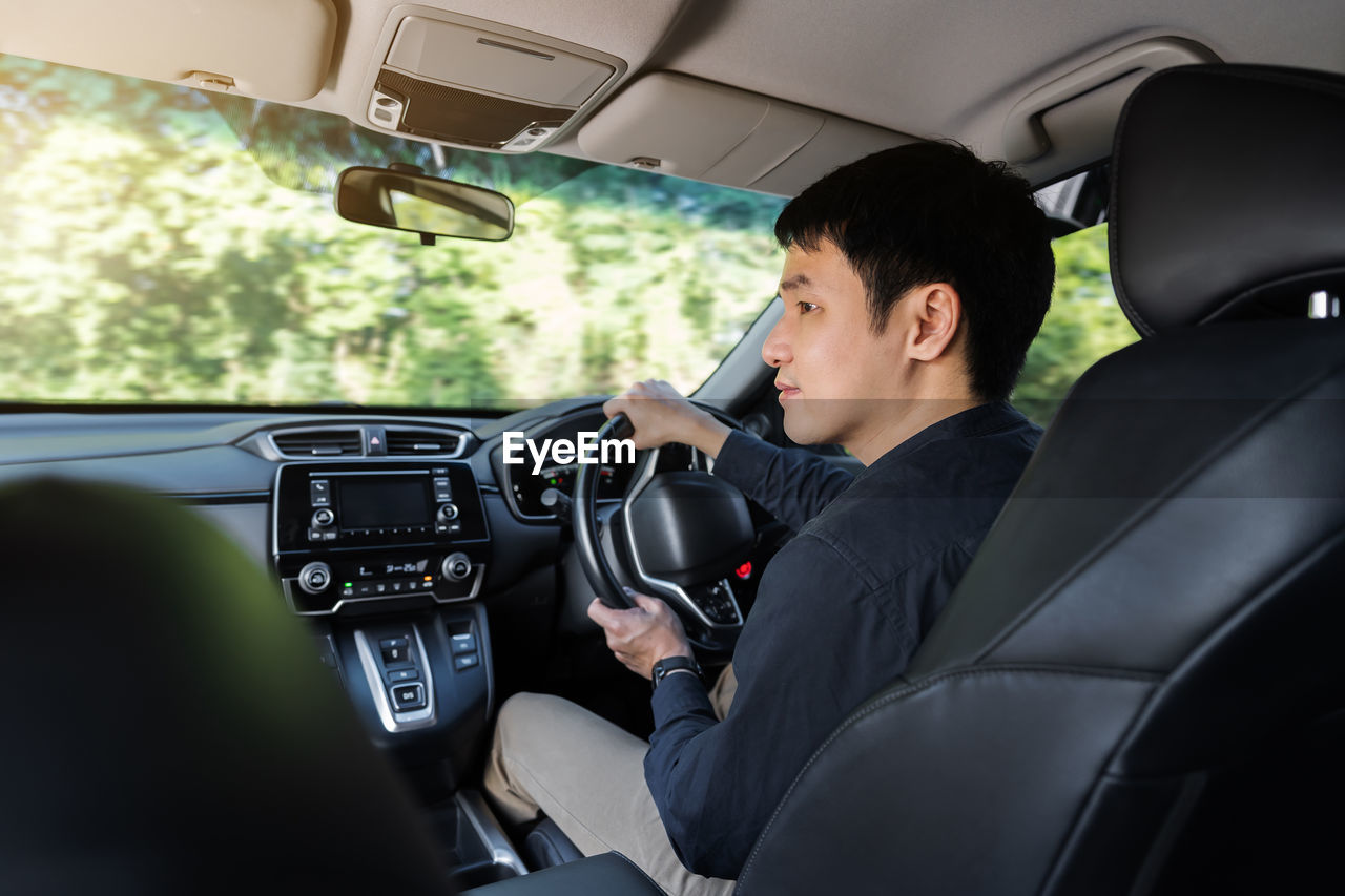 rear view of man driving car