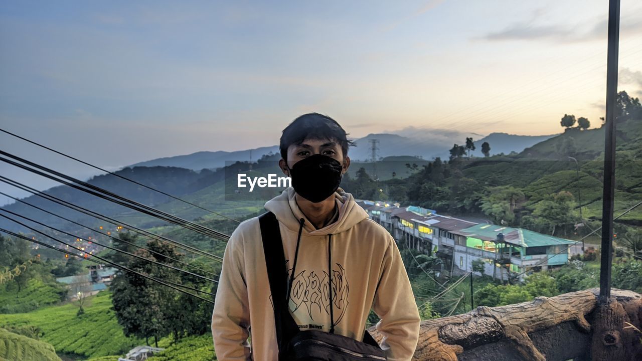 Portrait of man standing against mountain