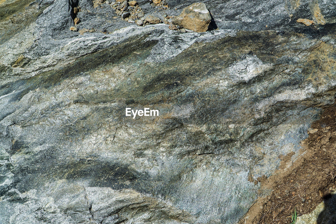 FULL FRAME SHOT OF ROCKS ON SHORE