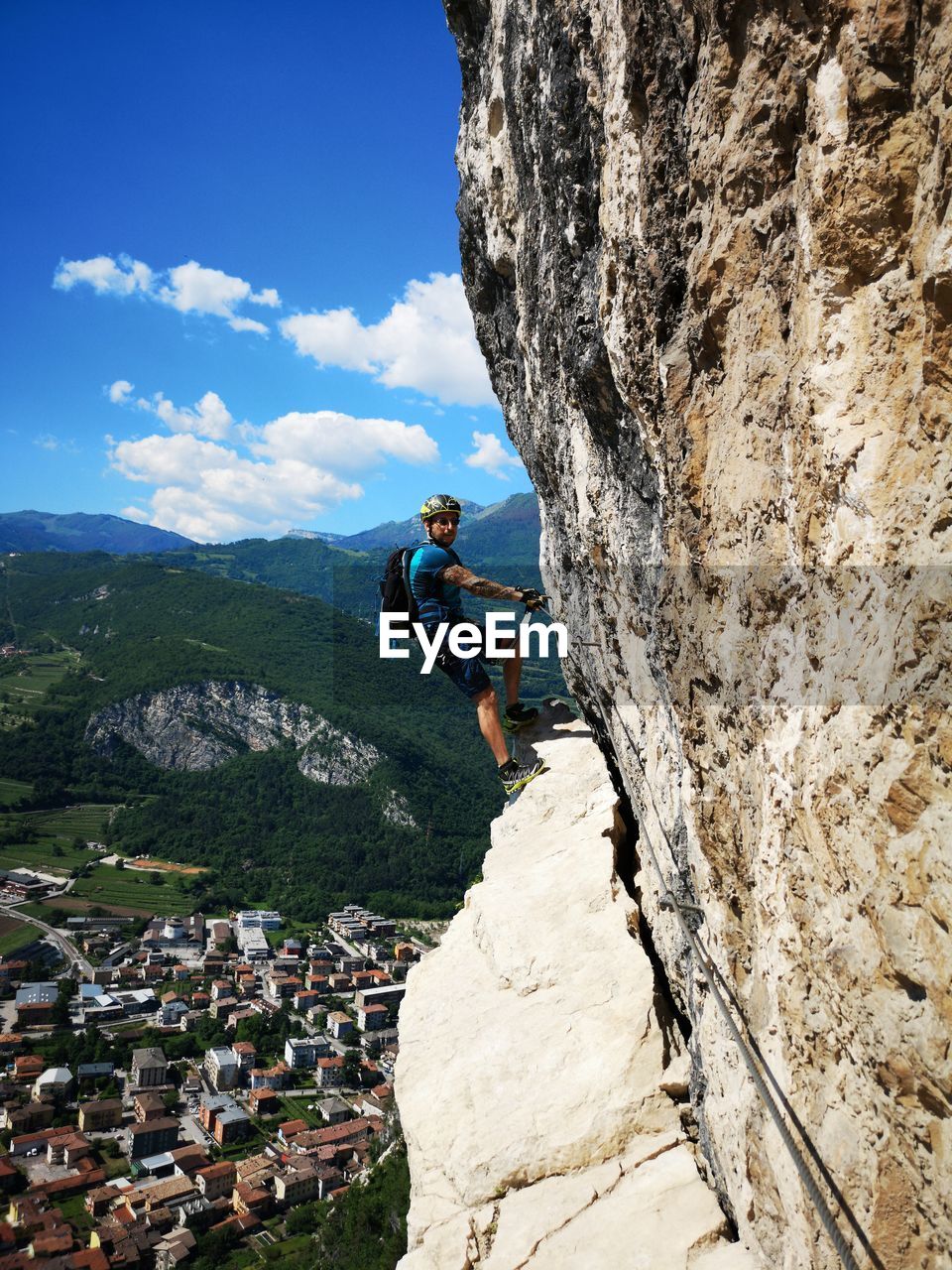 Side view of man climbing on rock