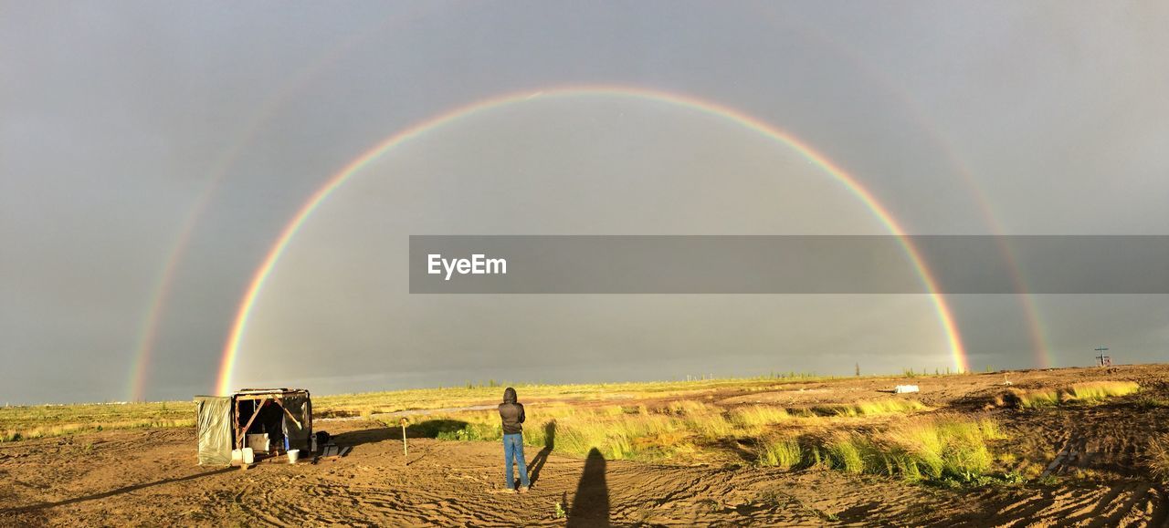 SCENIC VIEW OF RAINBOW OVER LAND