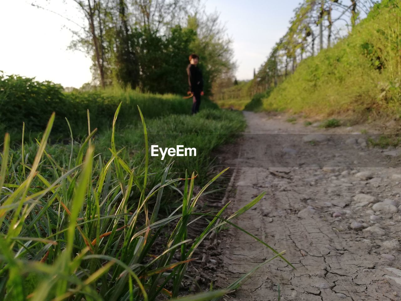 MAN WALKING ON FIELD