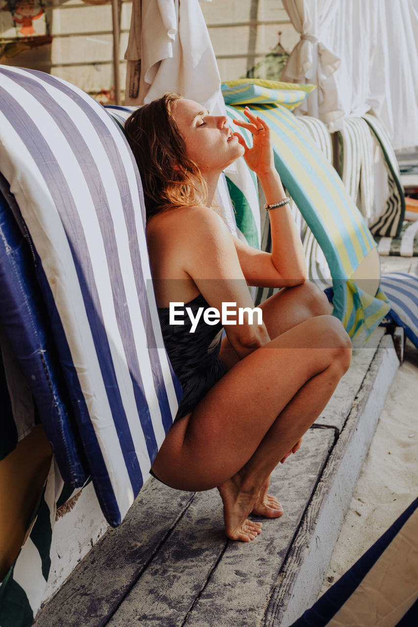 Young woman sitting at beach