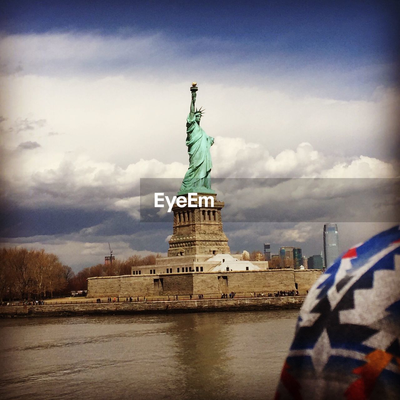 STATUE OF LIBERTY AGAINST SKY IN CITY