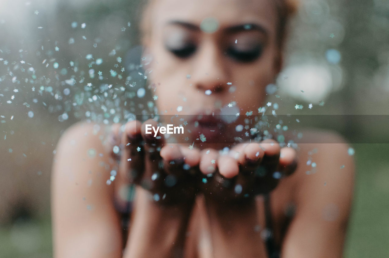 PORTRAIT OF WOMAN WITH WATER DROPS IN RAIN