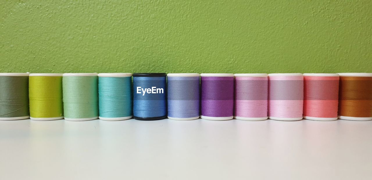 Close-up of colorful spools on table