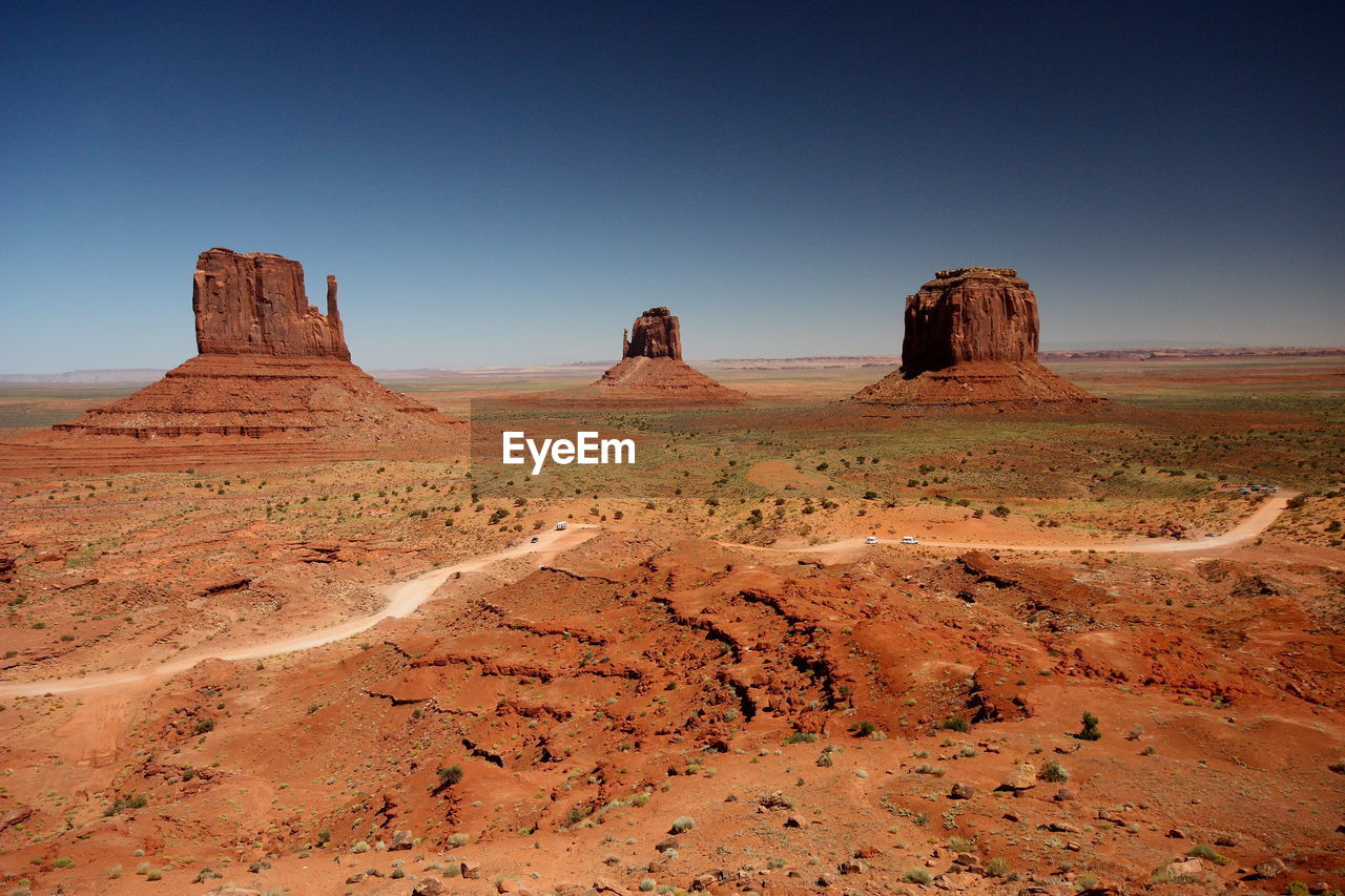 Scenic view of monument valley against clear blue sky