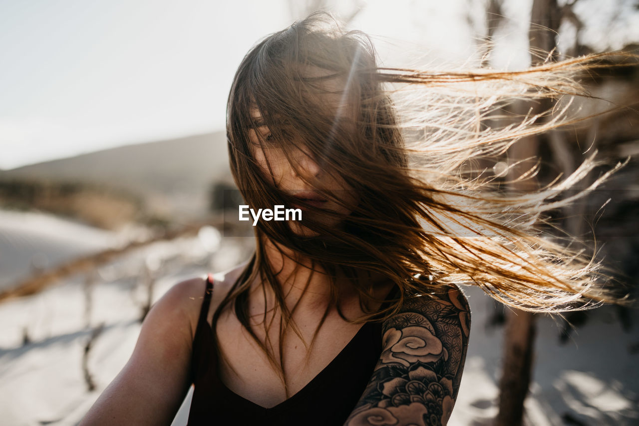 Young woman with long hair at beach