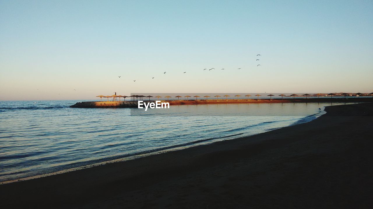 Idyllic view of beach against sky