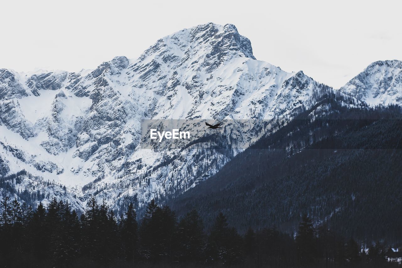 Scenic view of snowcapped mountains against clear sky