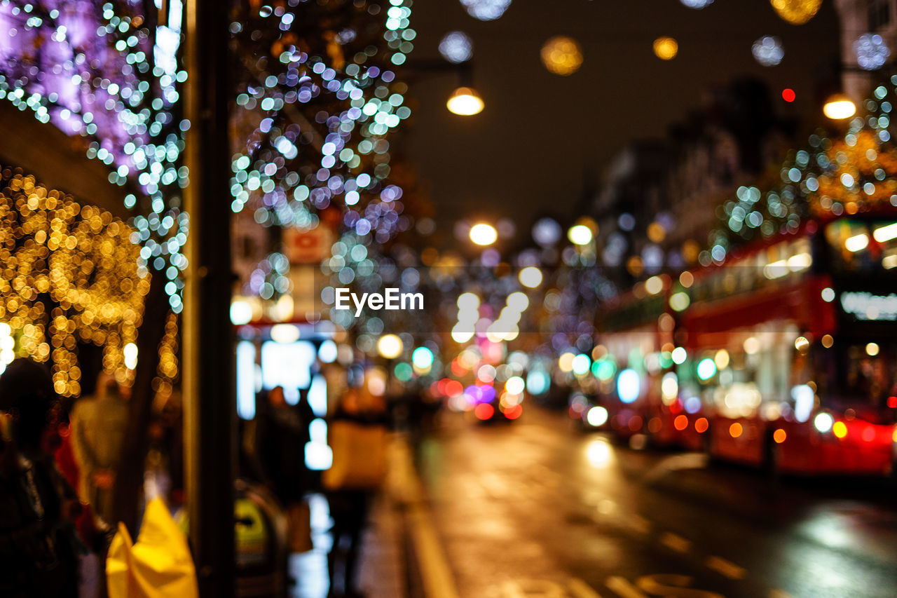 DEFOCUSED IMAGE OF ILLUMINATED CITY STREET