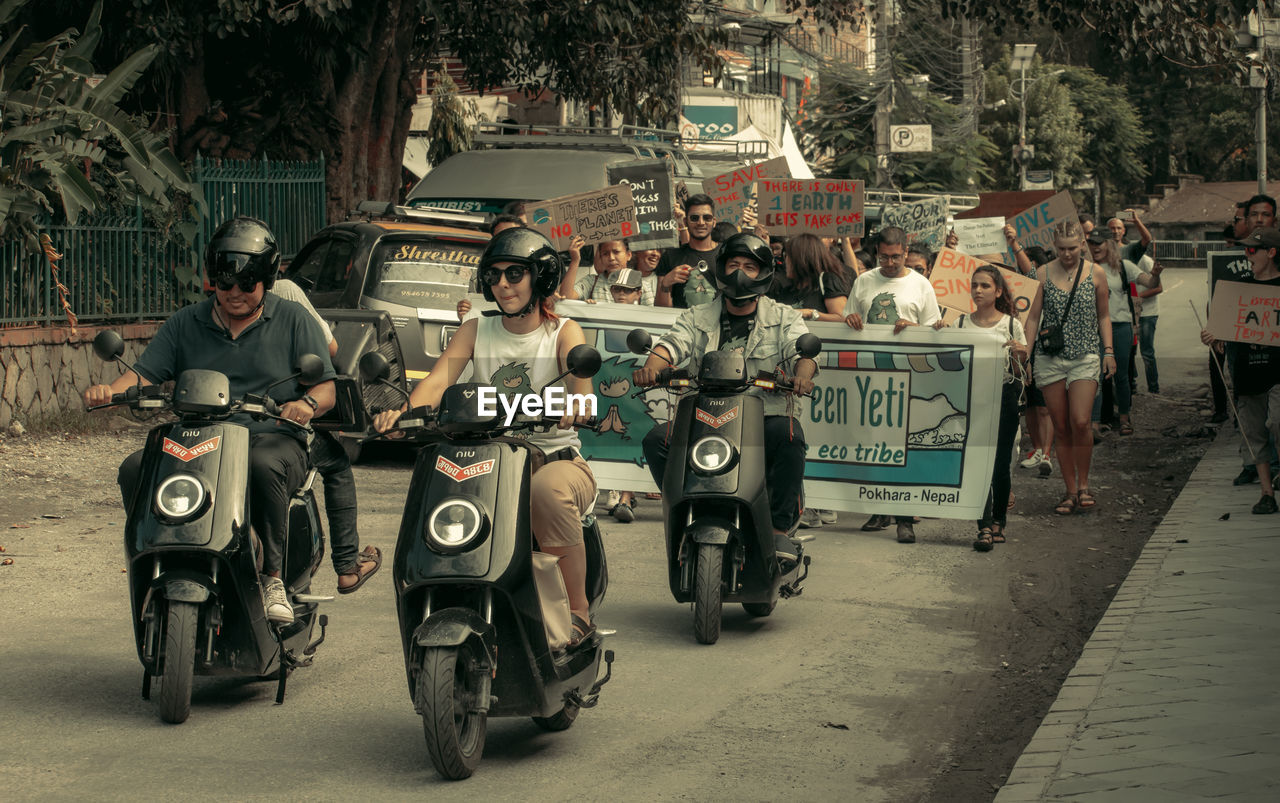 GROUP OF PEOPLE ON STREET IN CITY