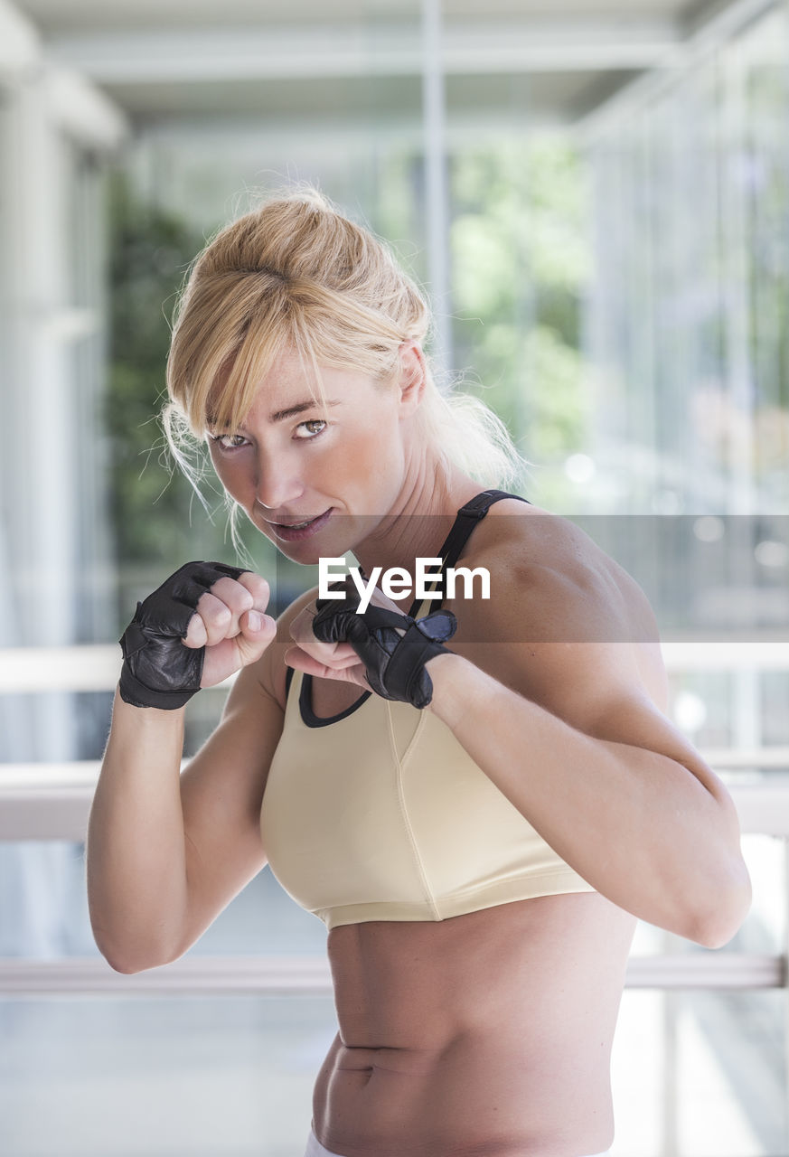 Portrait of muscular woman in fighting stance