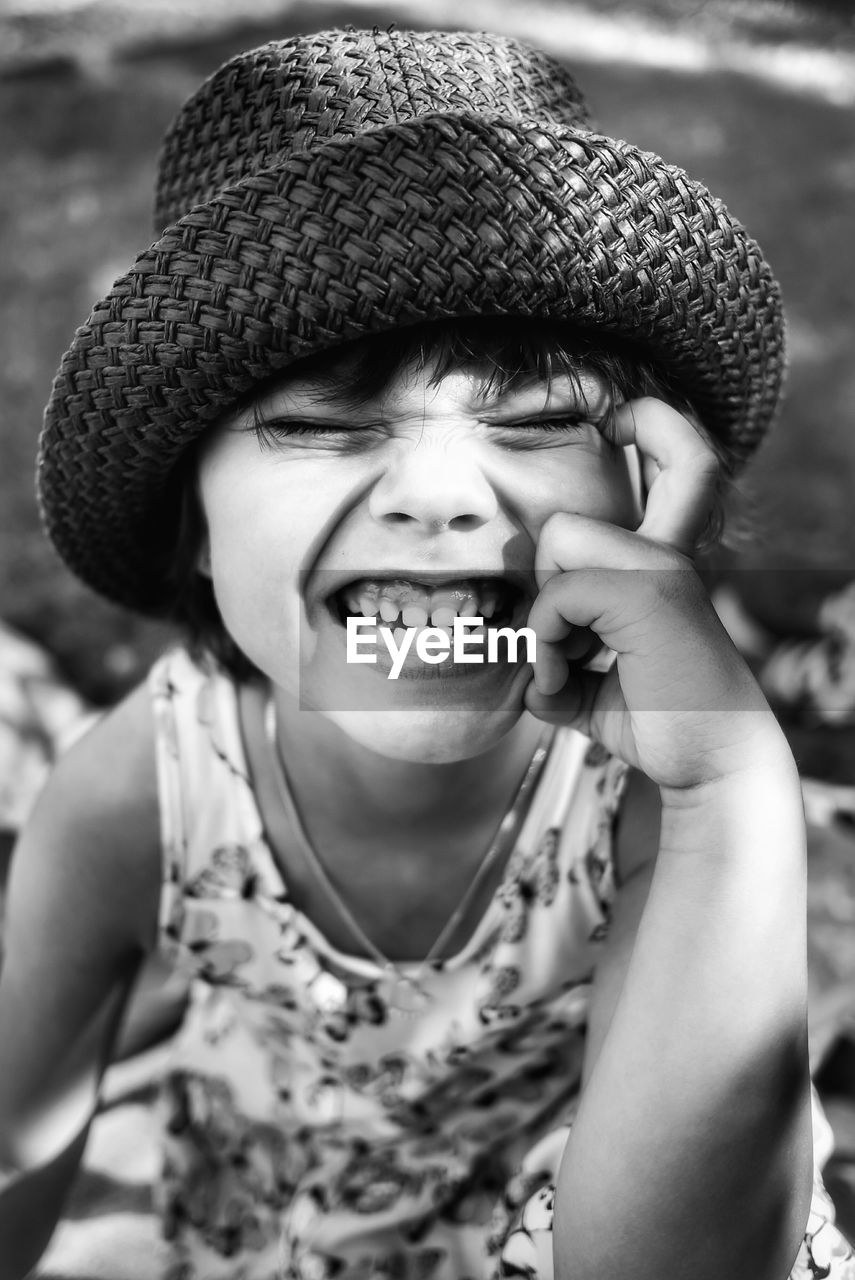 CLOSE-UP PORTRAIT OF HAPPY BOY WITH HAT