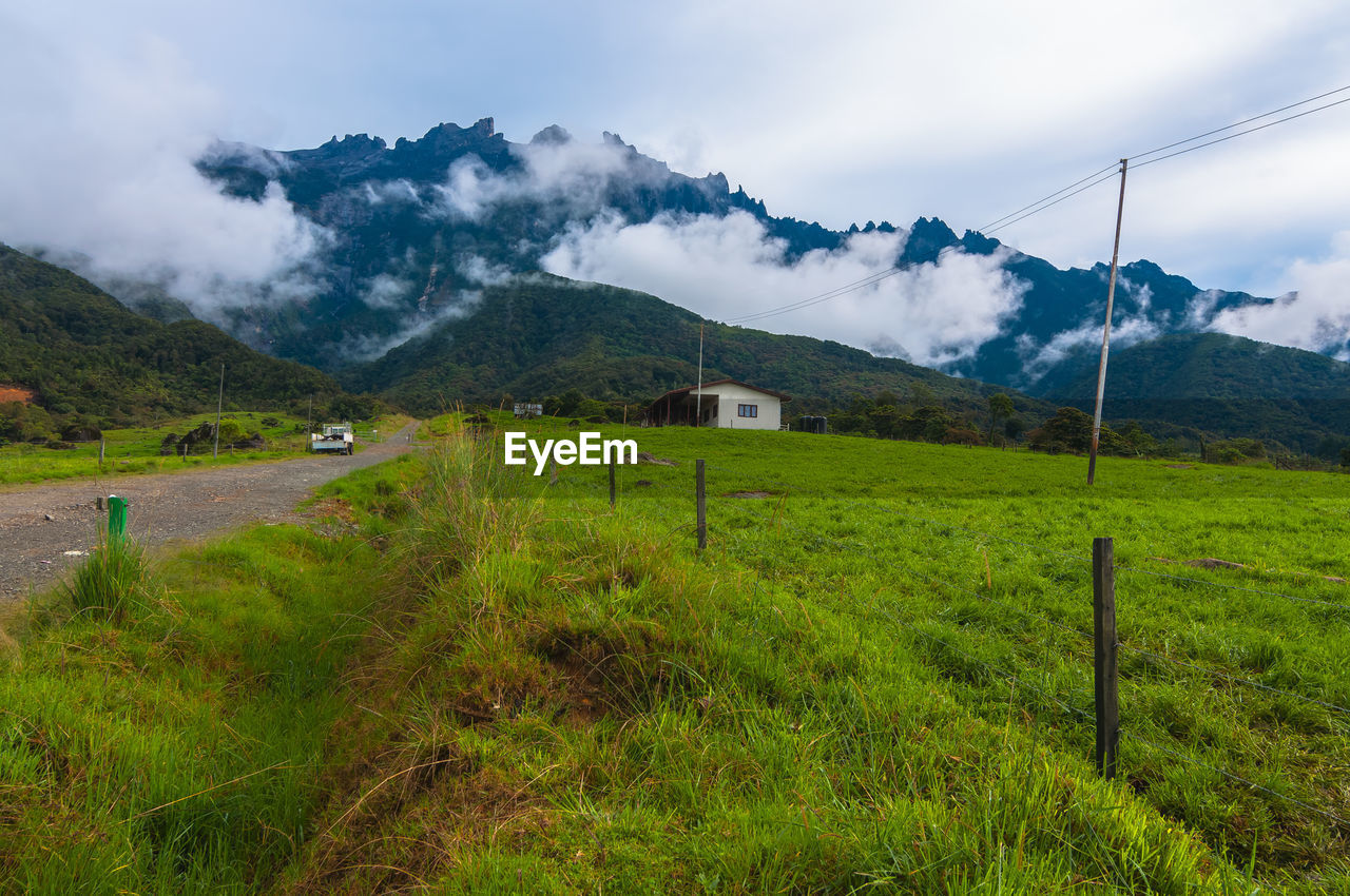 Scenic view of field against cloudy sky