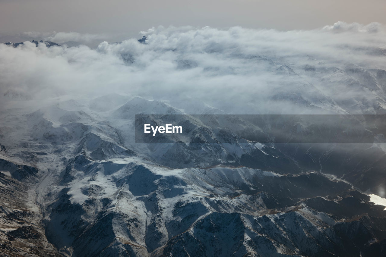 aerial view of snowcapped mountain against sky