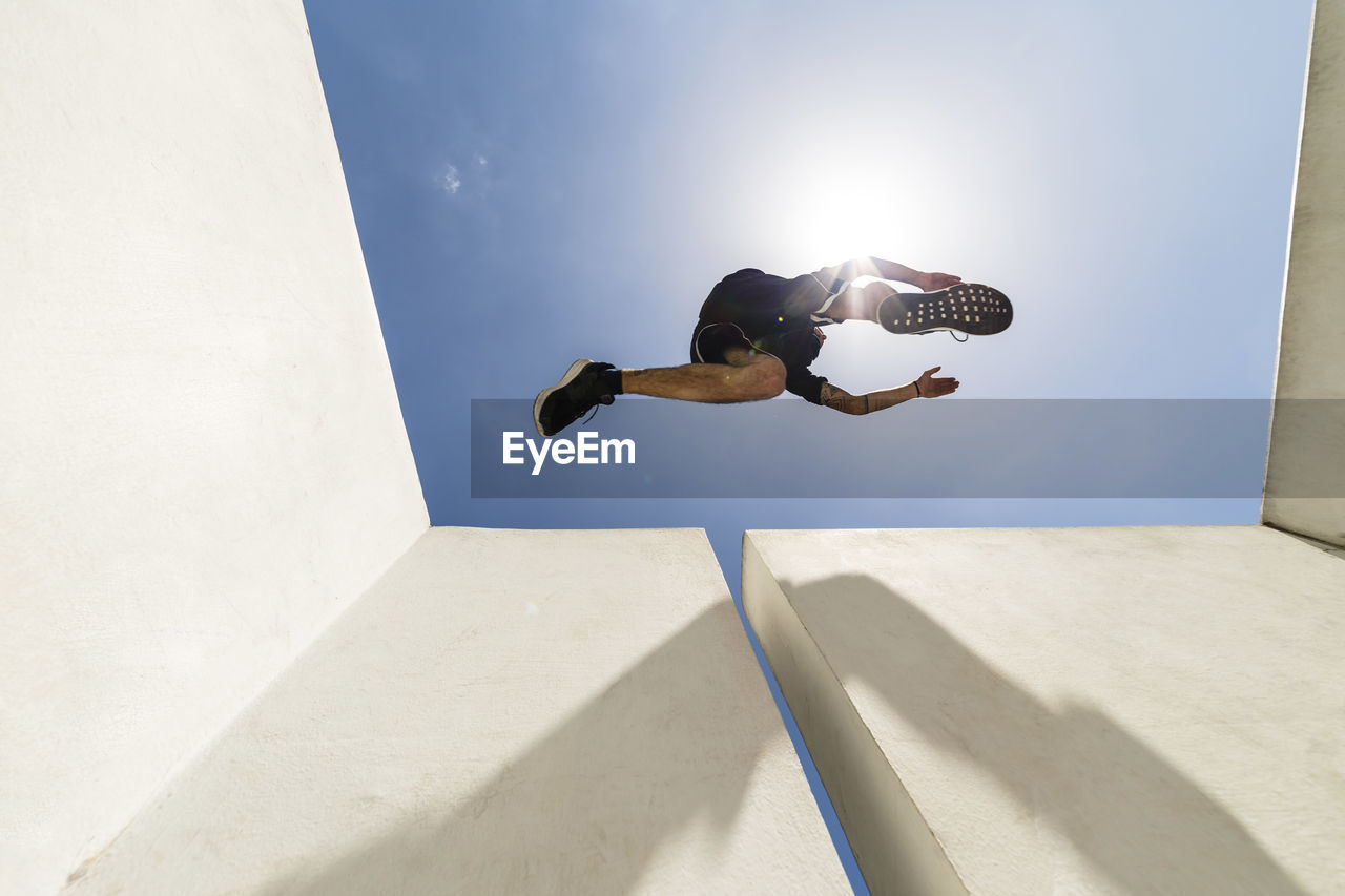 Man jumping in the city during a parkour session