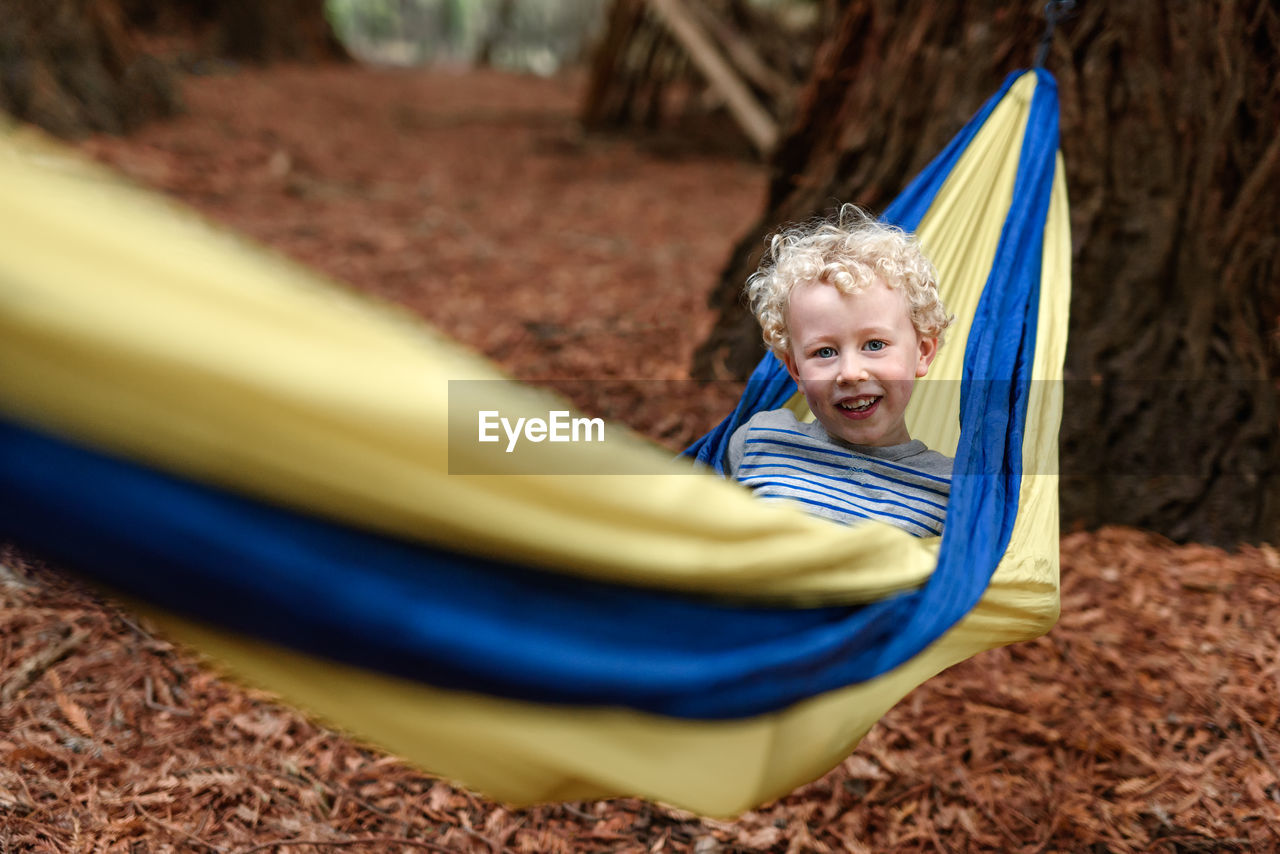 Cute young child in a yellow hammock