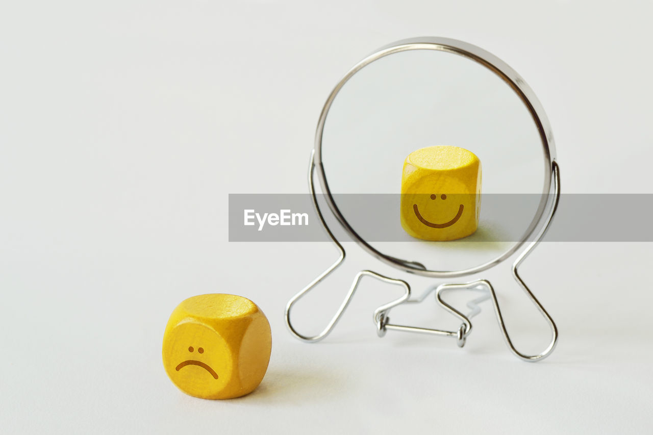 yellow, studio shot, indoors, no people, smiley, emoticon, white background, cartoon, lighting, fun