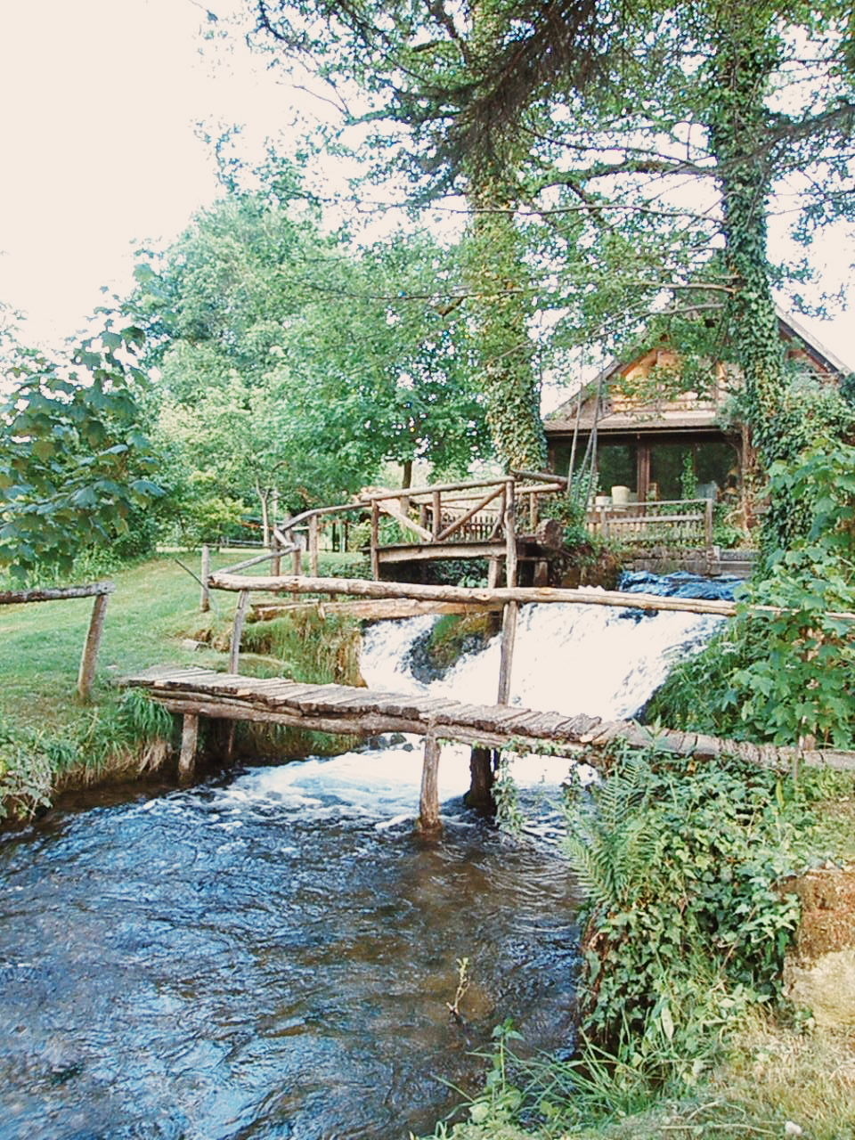 VIEW OF FOOTBRIDGE OVER RIVER