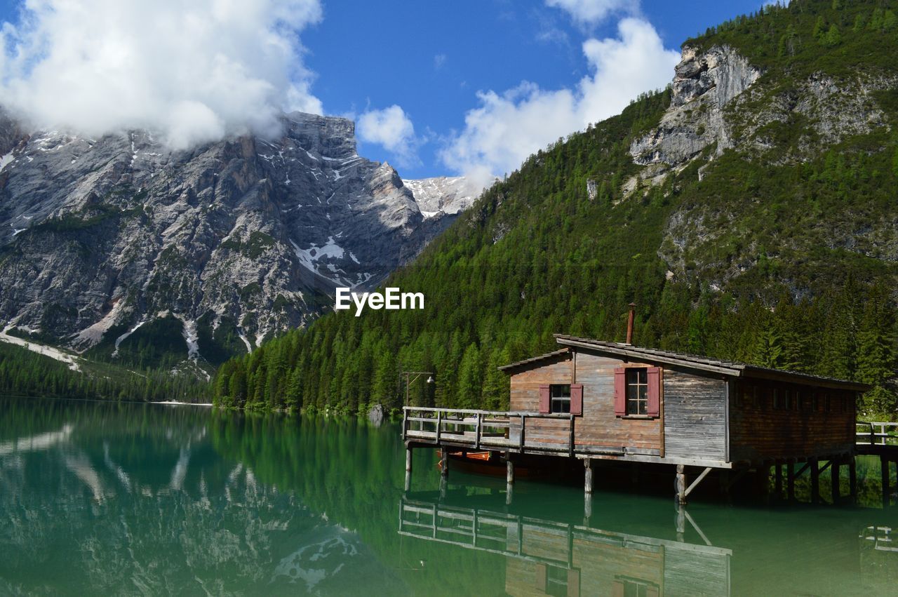 Scenic view of lake by mountain against sky