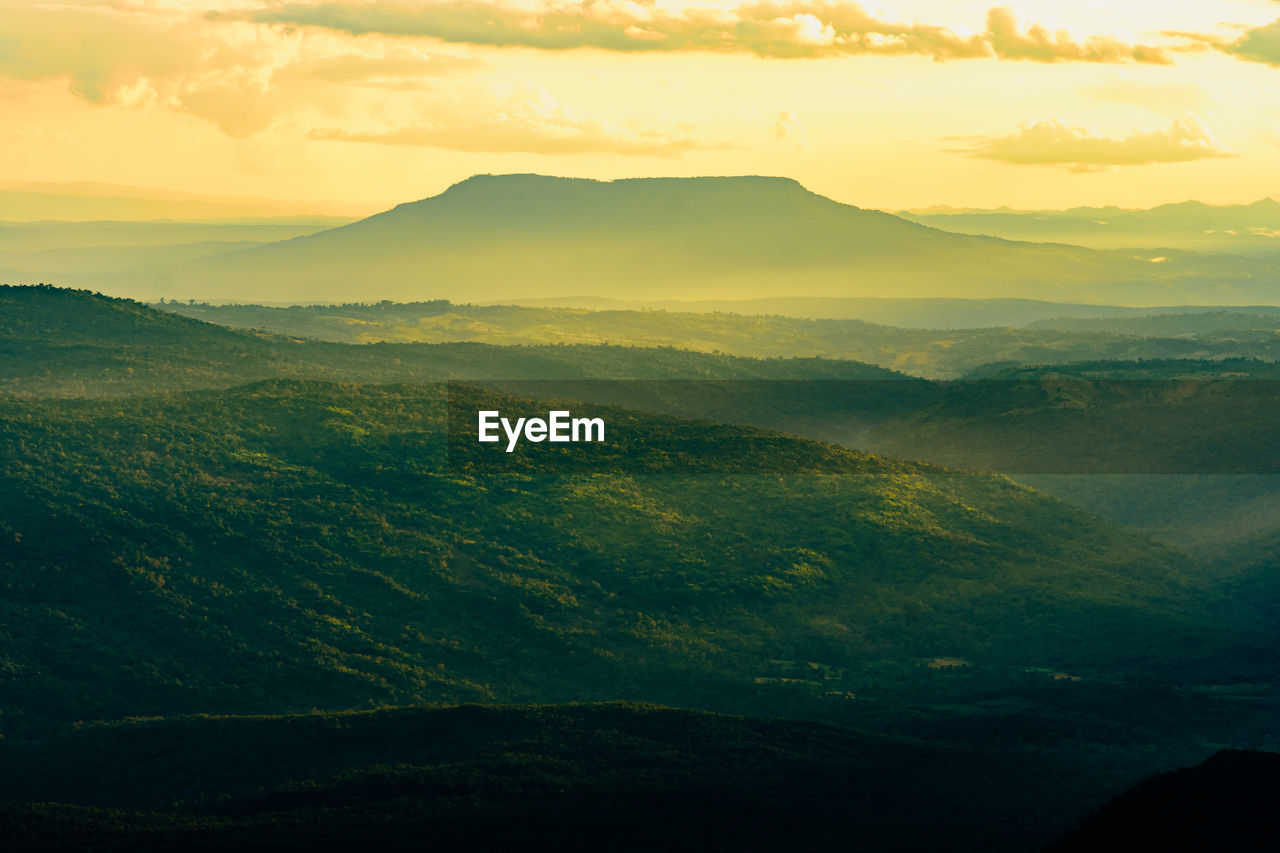 SCENIC VIEW OF LANDSCAPE AND MOUNTAINS AGAINST SKY DURING SUNSET