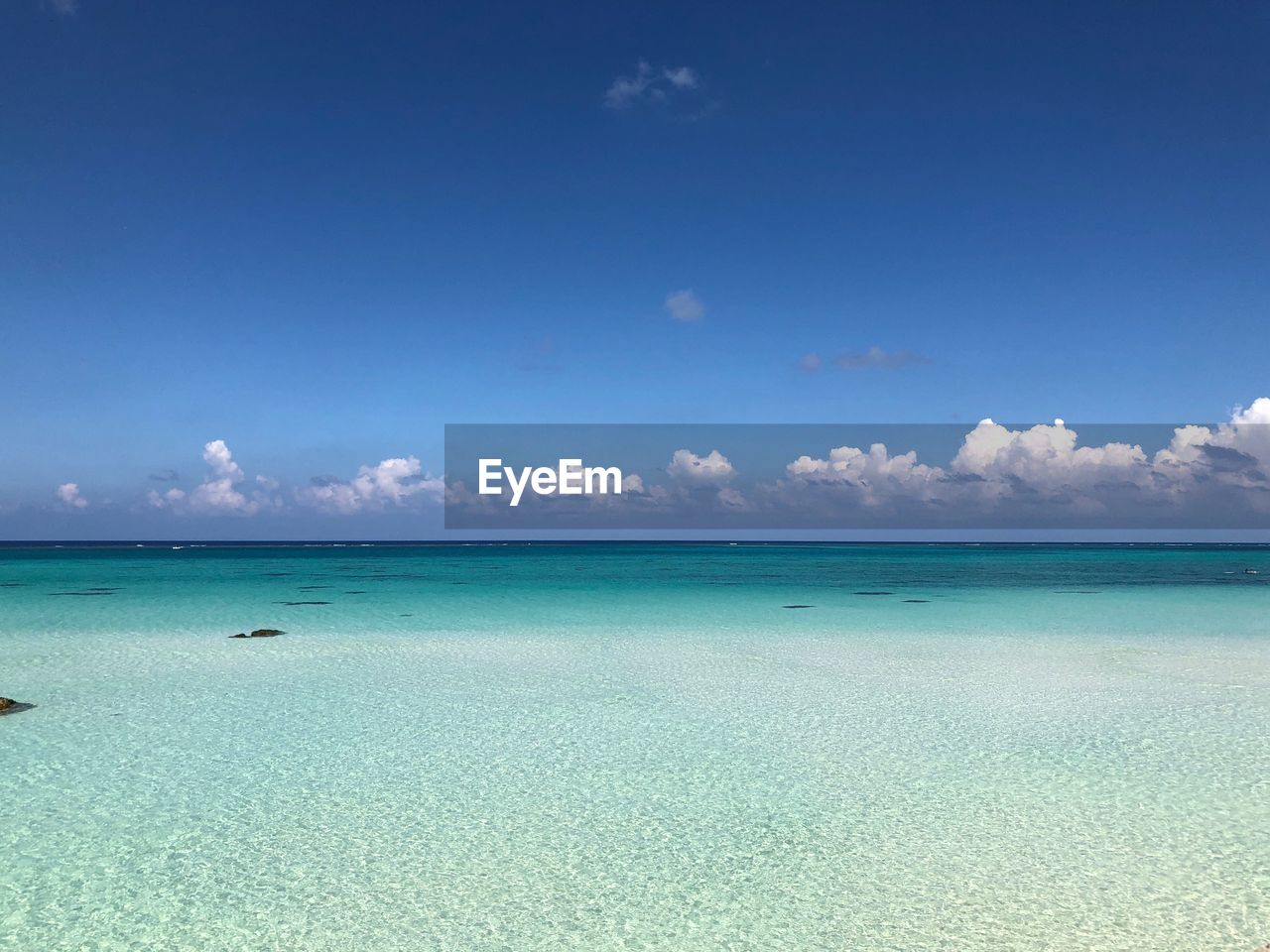 Scenic view of sea against blue sky