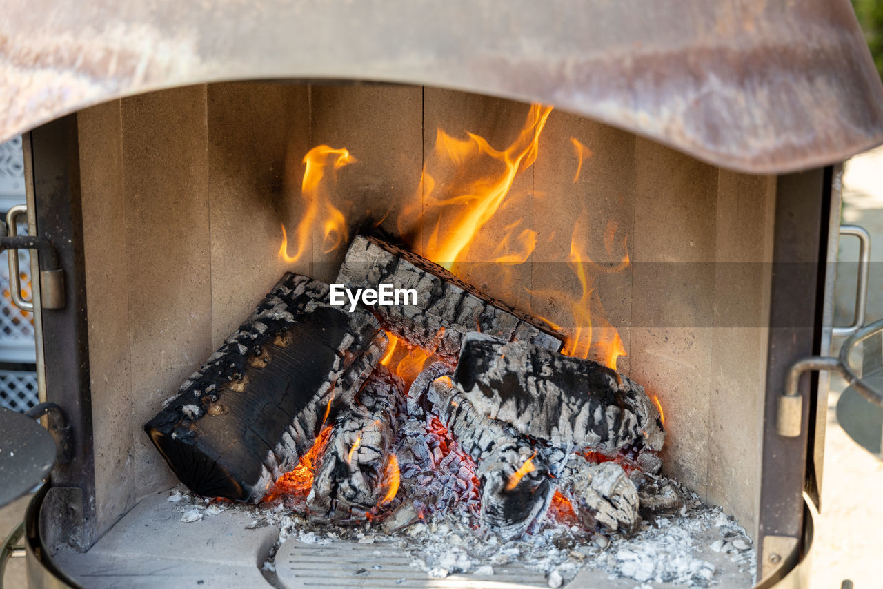 Burning wood in a fireplace with a lot of hot embers