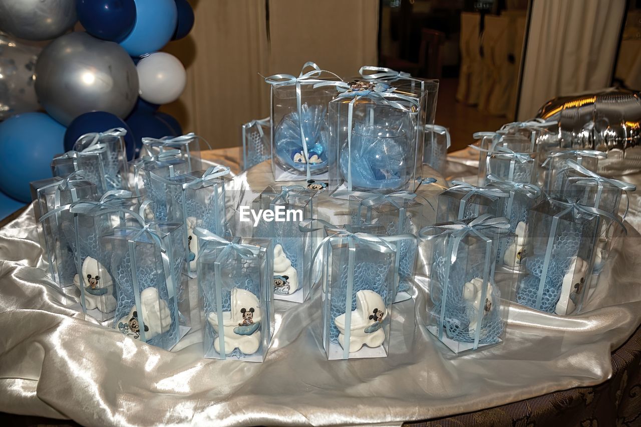 party, blue, large group of objects, centrepiece, no people, indoors, celebration, glass, table, drinking glass, event, still life, decoration, household equipment, balloon, abundance, arrangement, silver