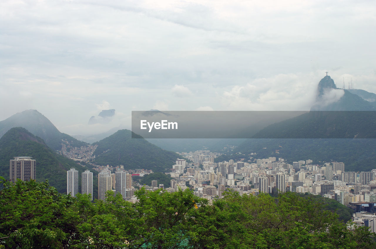 High angle view of buildings and mountains against sky