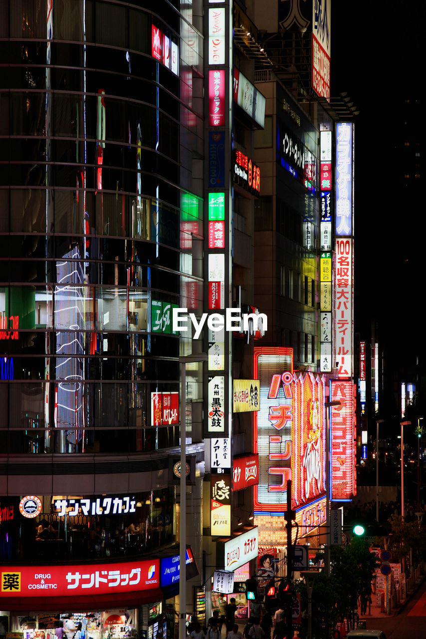 Illuminated billboards on buildings in city at night