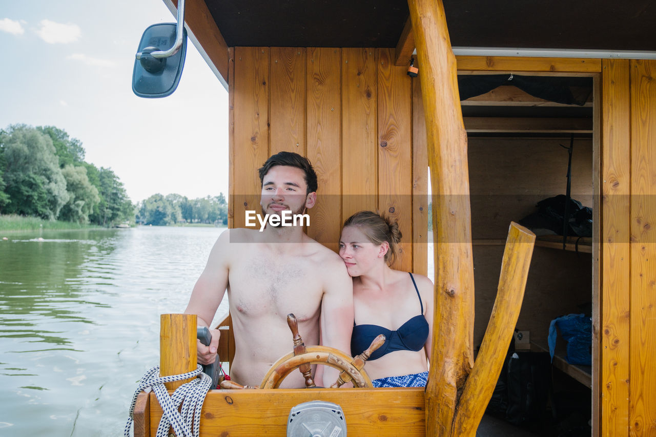 Couple sitting in boat over river