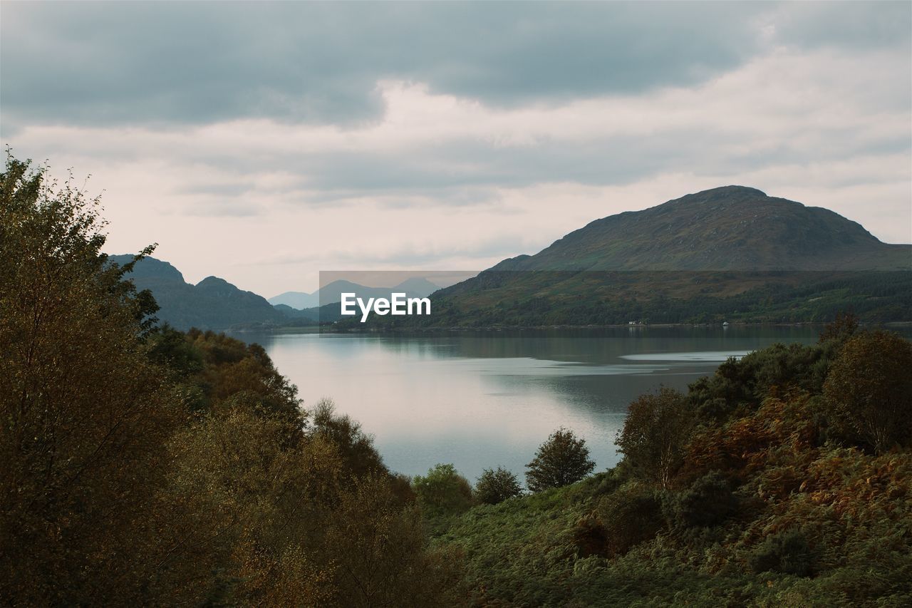 SCENIC VIEW OF MOUNTAINS AGAINST CLOUDY SKY