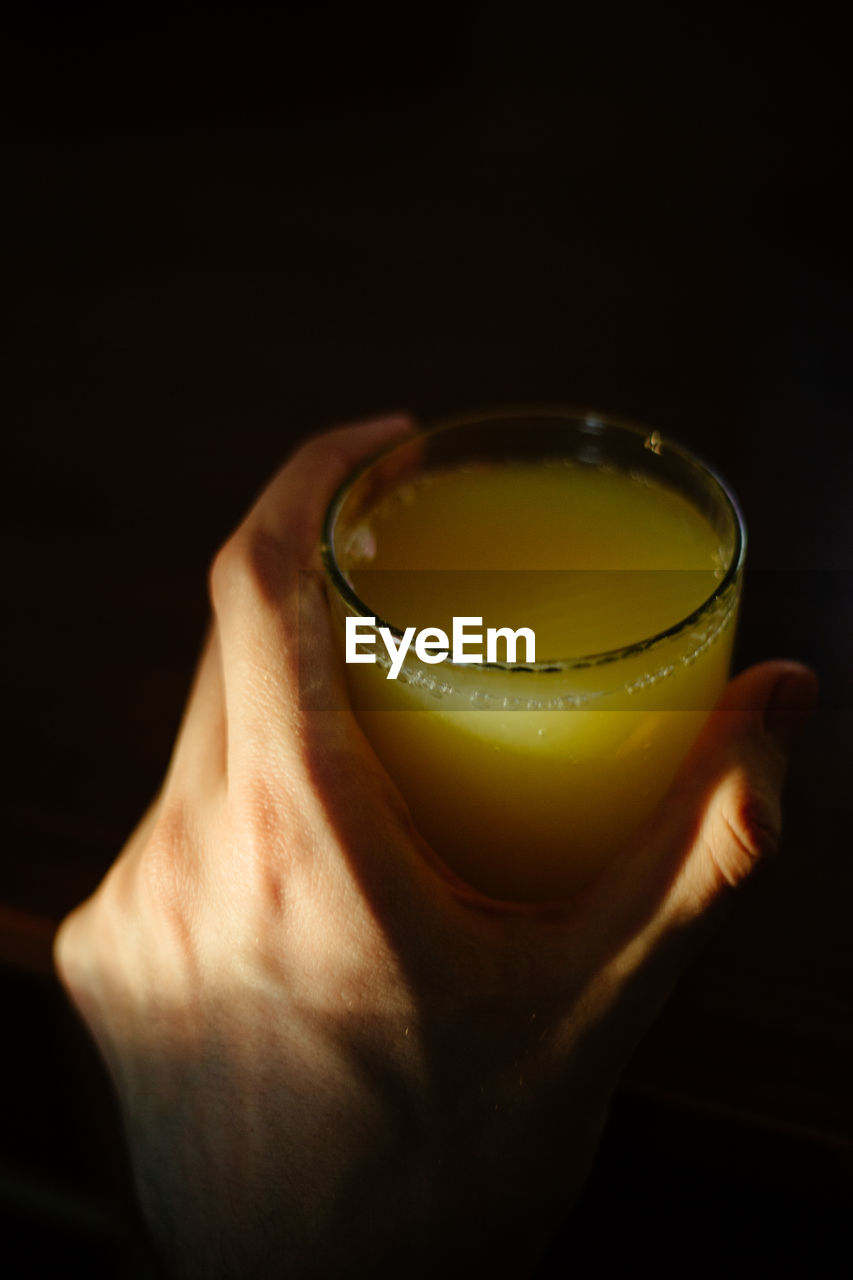 Close-up of person holding a cup with juice