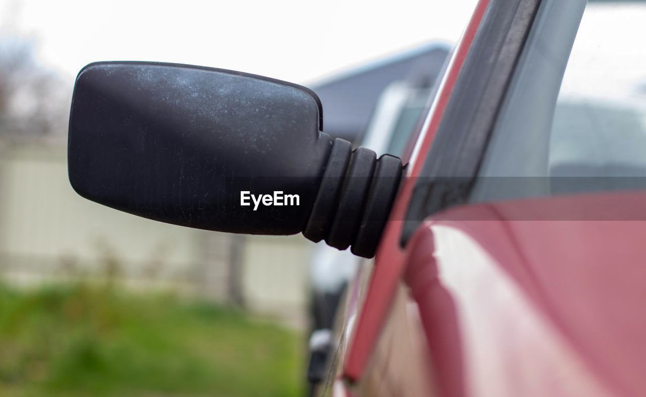 transportation, mode of transportation, driving, car, motor vehicle, vehicle, land vehicle, travel, mirror, rear-view mirror, outdoors, nature, close-up, day, wheel, fuel pump, technology, automotive mirror, power generation, focus on foreground